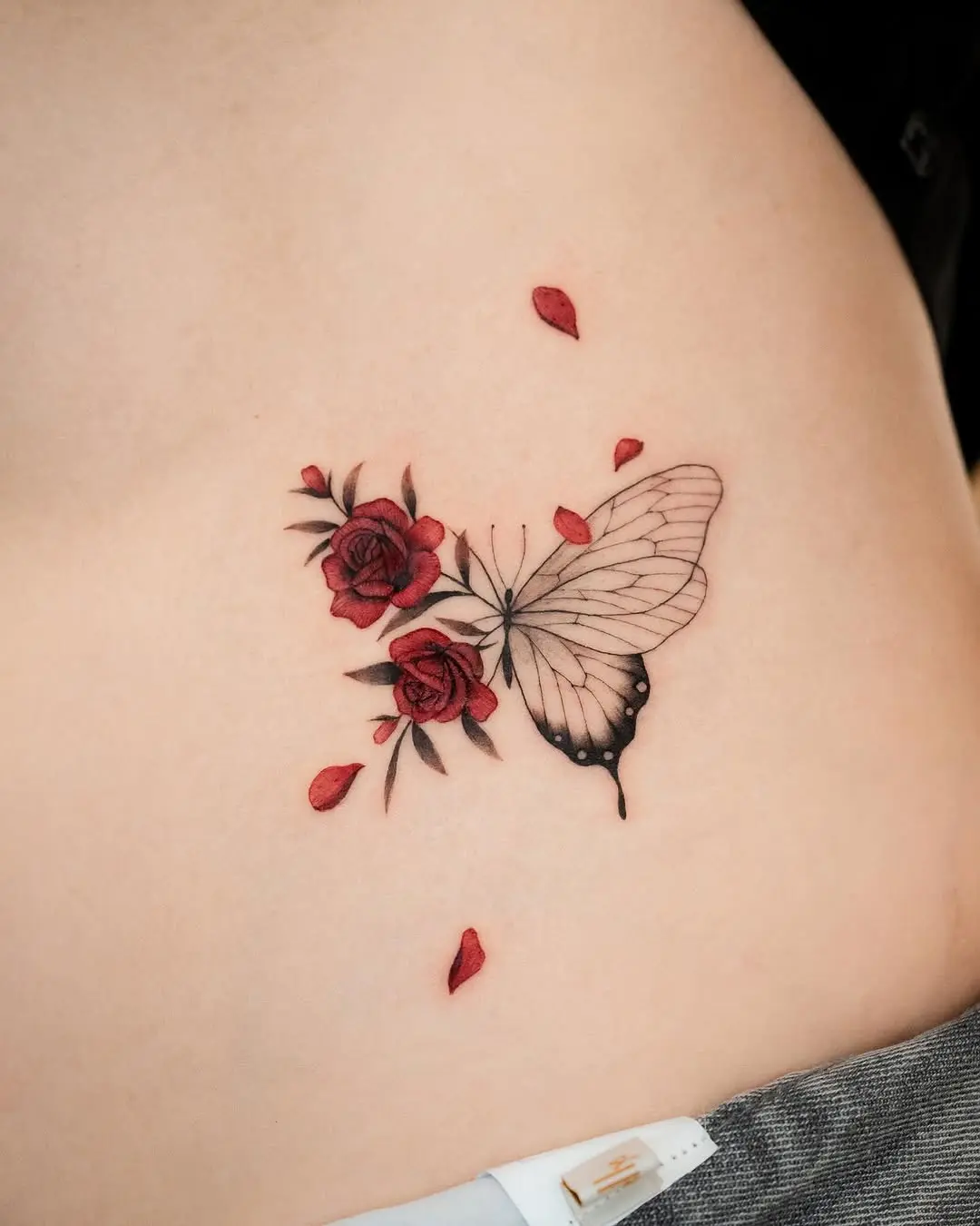Beautiful butterfly tattoo with red roses