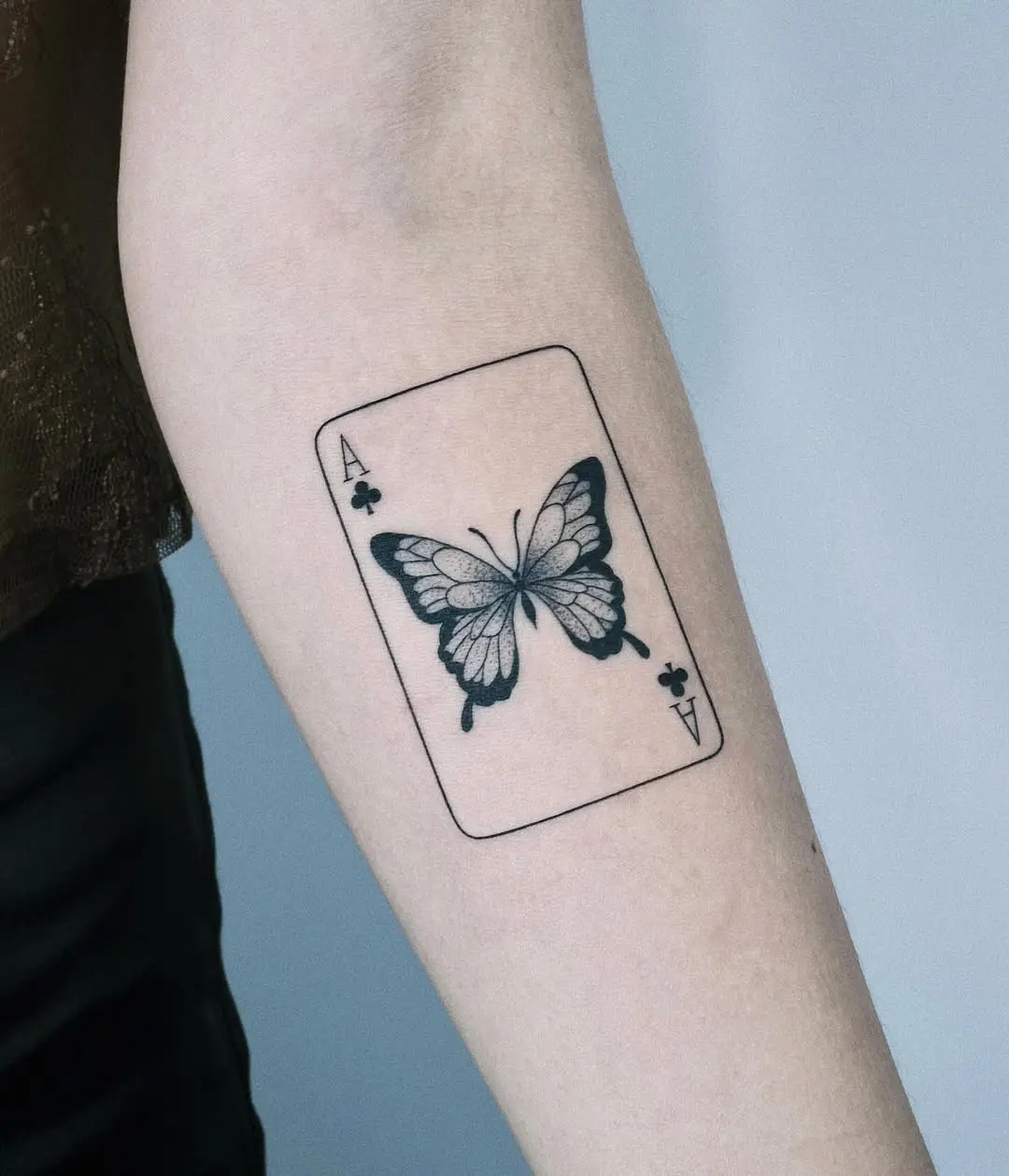 Butterfly tattoo with playing card design
