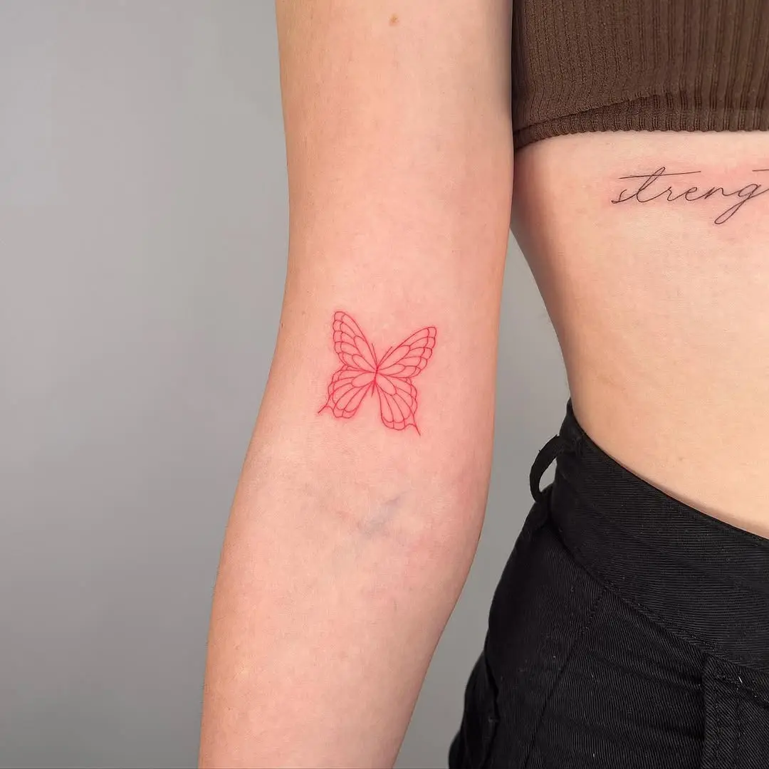 Delicate butterfly tattoo on inner arm