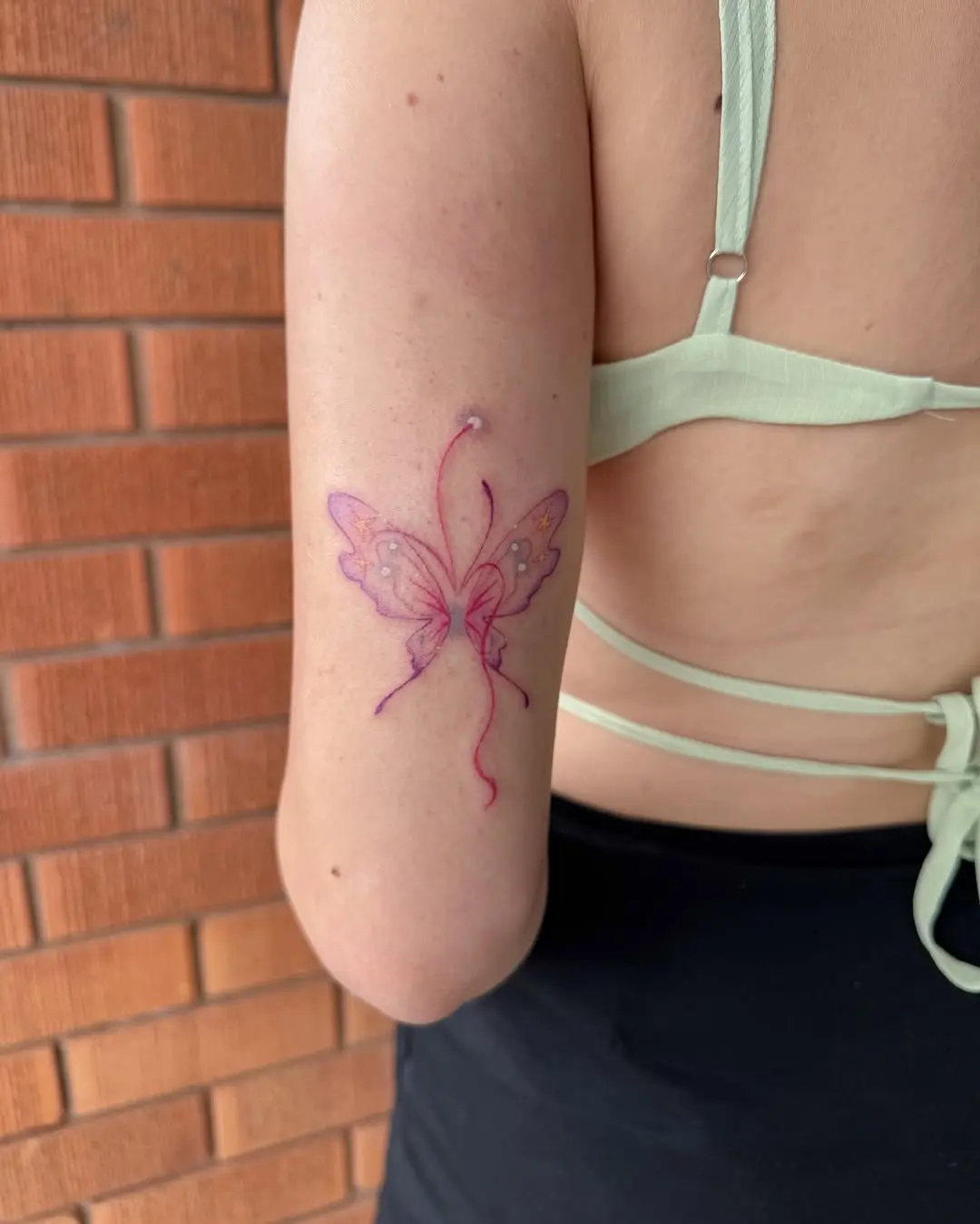 Elegant butterfly tattoo with delicate details