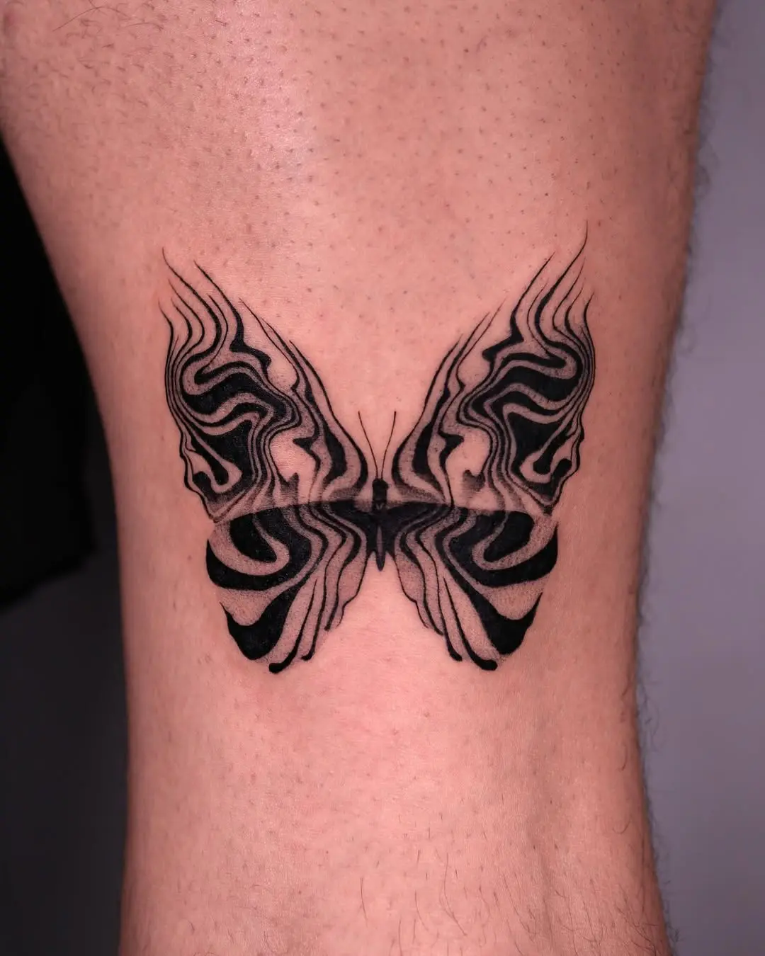 Abstract butterfly tattoo with intricate designs