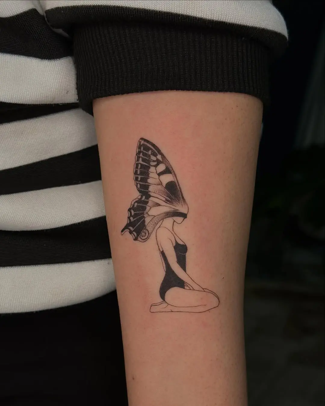 Unique butterfly tattoo blending art and femininity