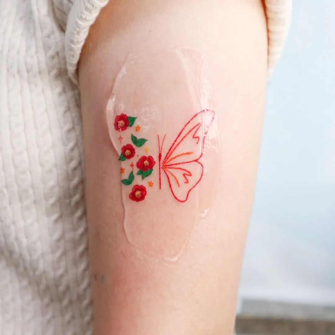 Charming butterfly tattoo with floral accents