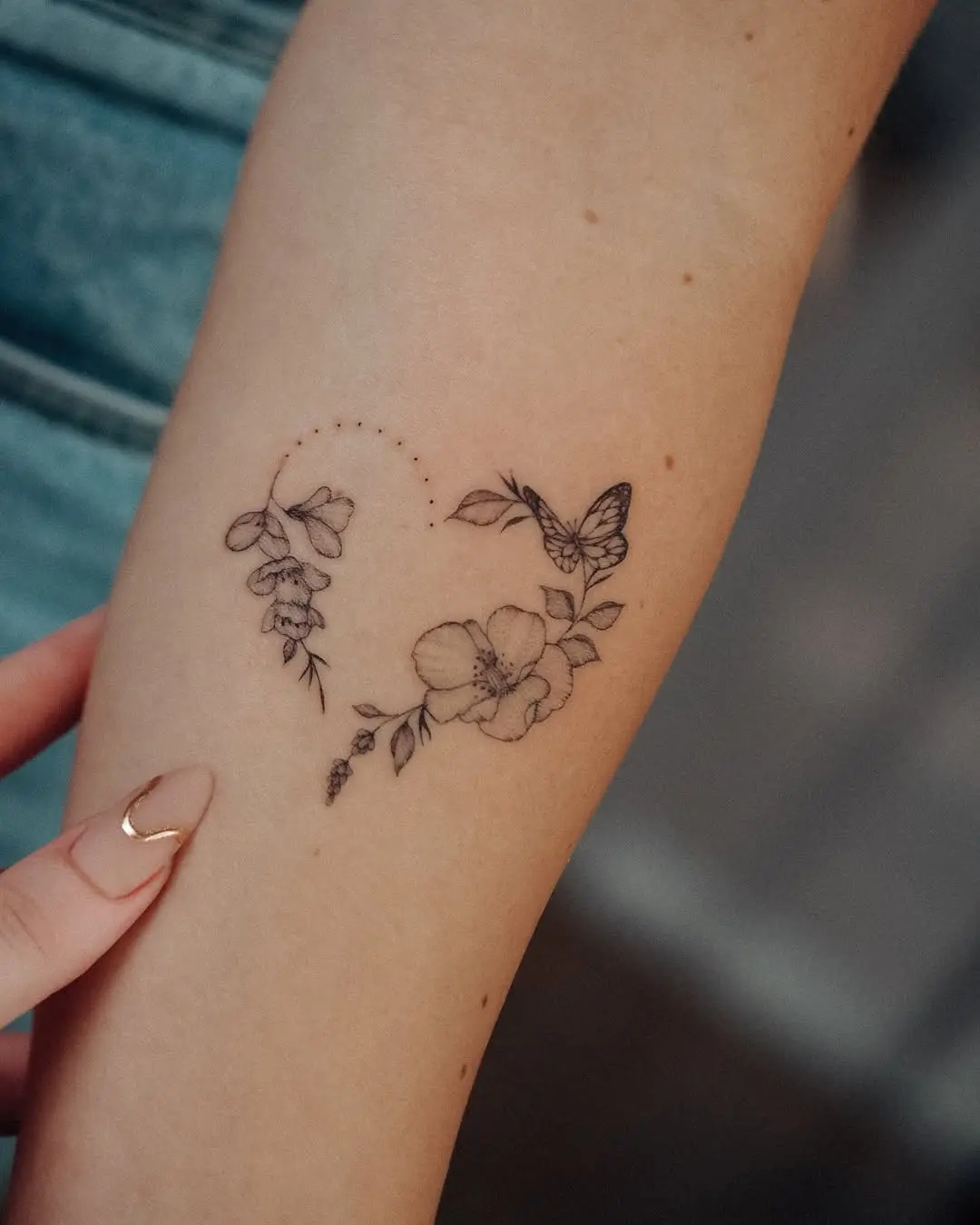 Delicate butterfly tattoo entwined with floral elements