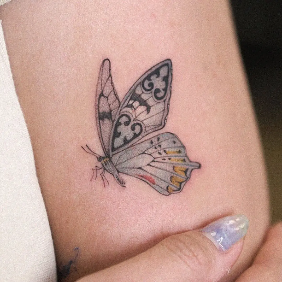 Elegant butterfly tattoo with intricate patterns
