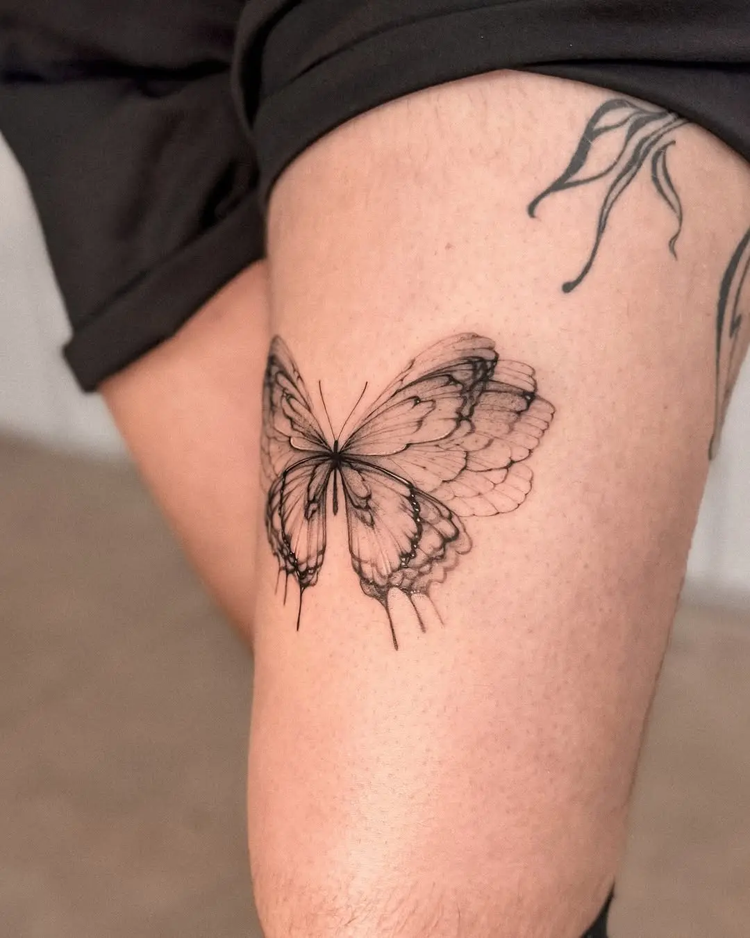 Intricate butterfly tattoo on leg