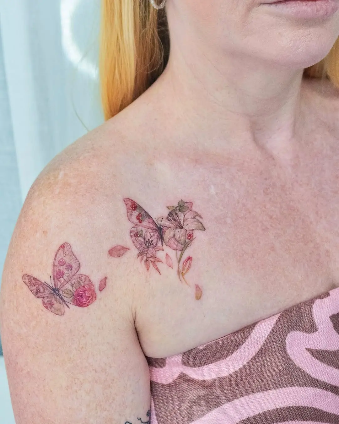 Delicate butterfly tattoo with floral accents