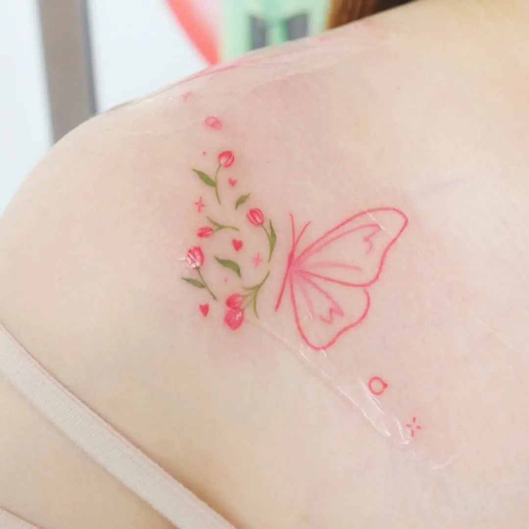 Delicate butterfly tattoo with floral elements