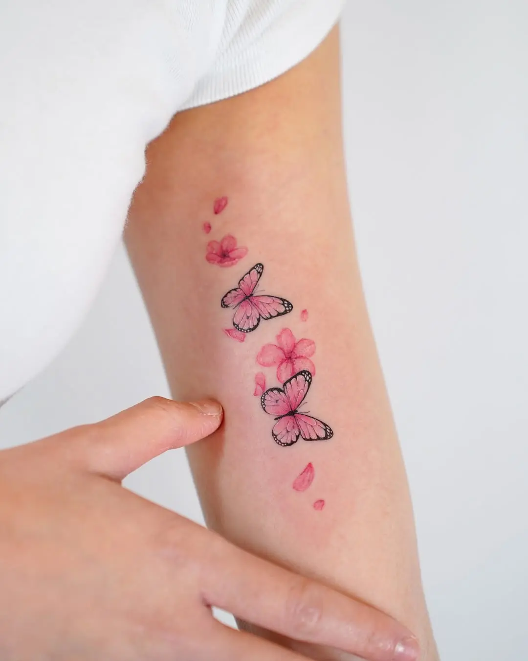 Vibrant butterfly tattoo with floral accents