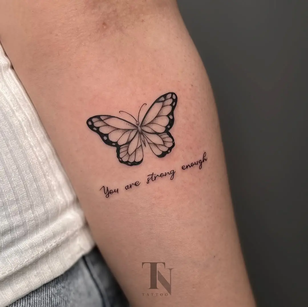 Elegant butterfly tattoo with a motivating message