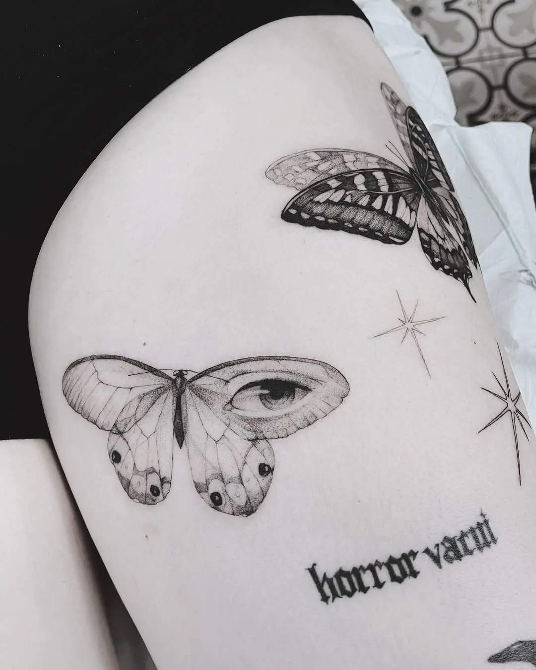 Realistic butterfly tattoo with mystical elements