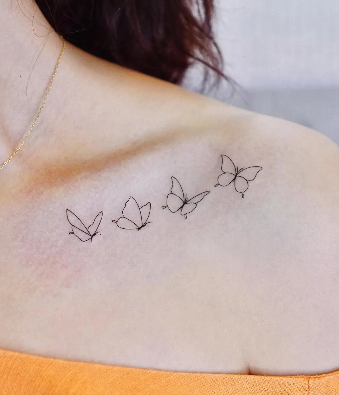 Charming minimalist butterfly tattoo design on shoulder