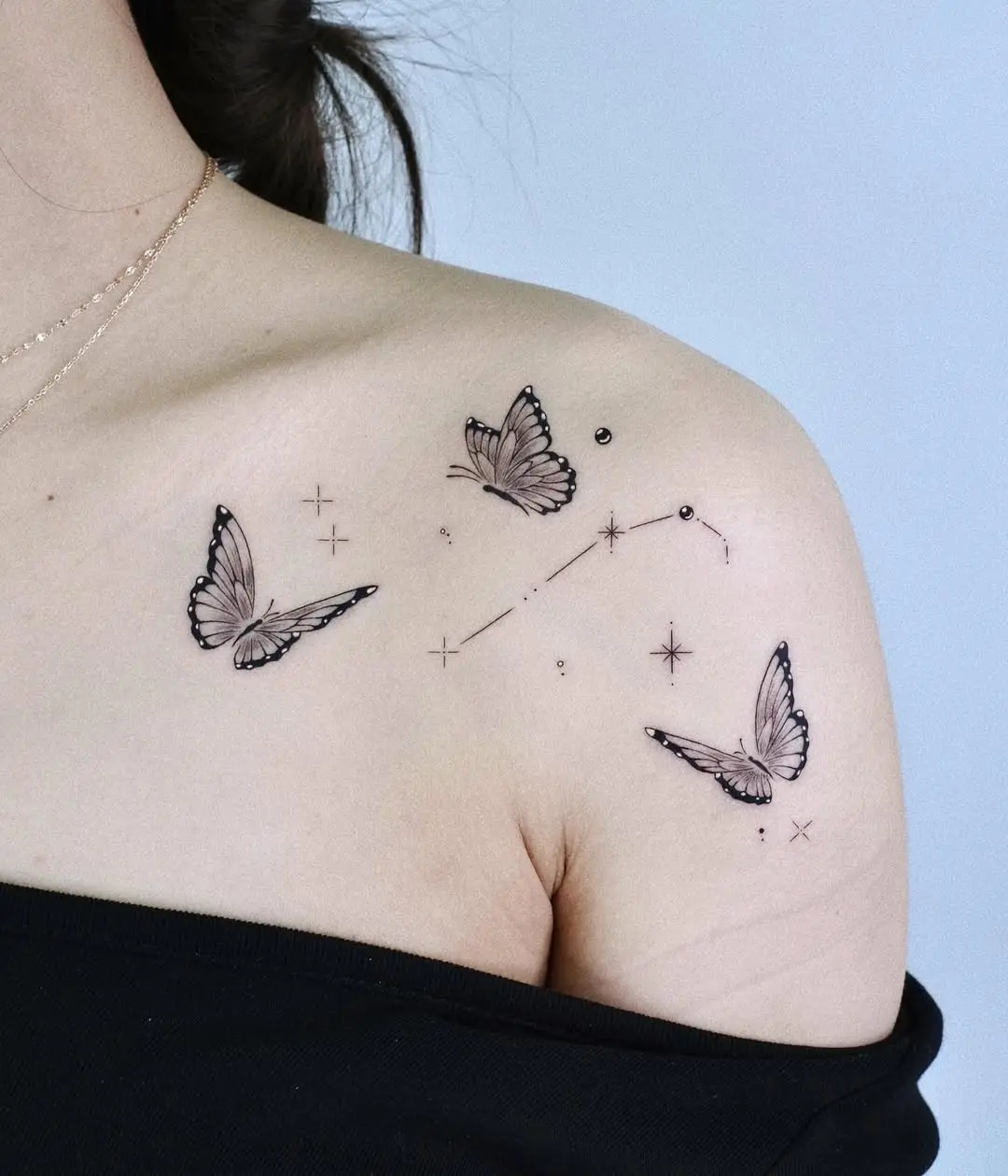 Elegant butterfly tattoo with celestial elements