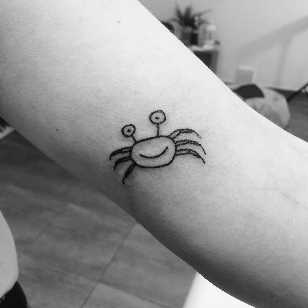 Charming minimalist Cancer zodiac crab tattoo