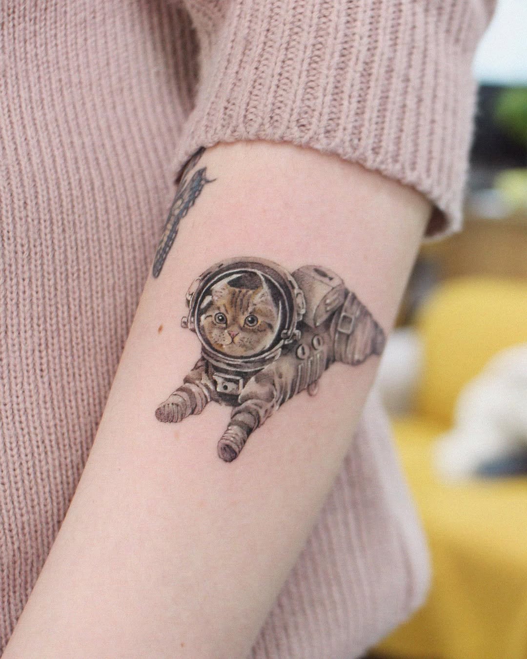 Adorable kitty in a space suit tattoo