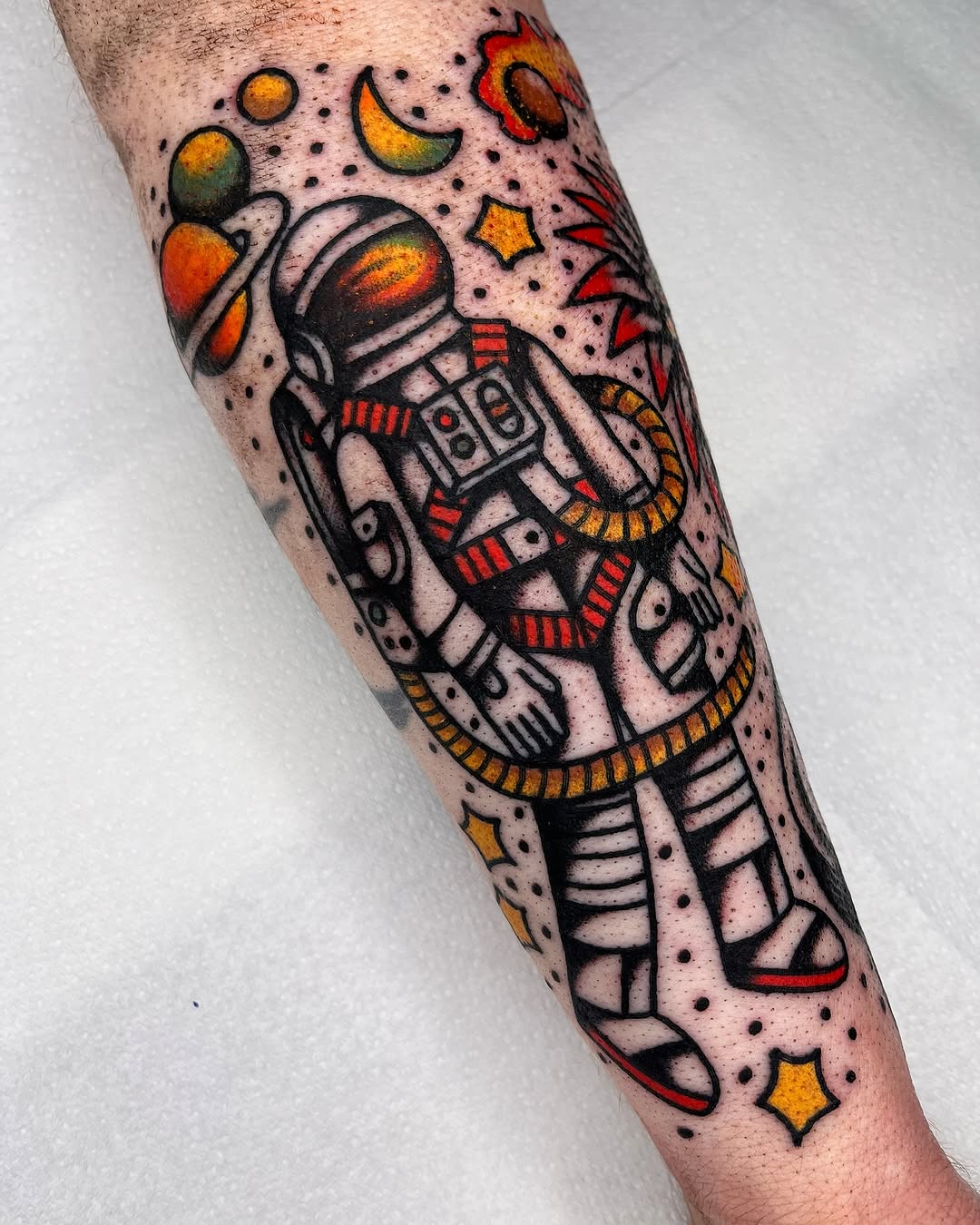 Vibrant astronaut tattoo with cosmic elements