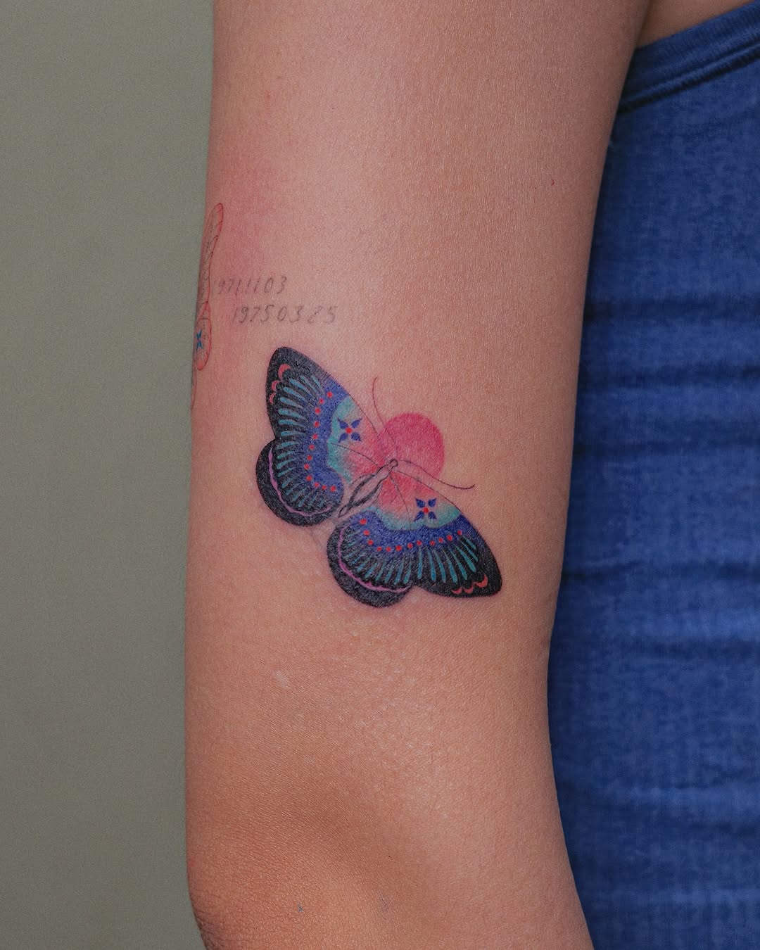 A vibrant butterfly tattoo in bright hues