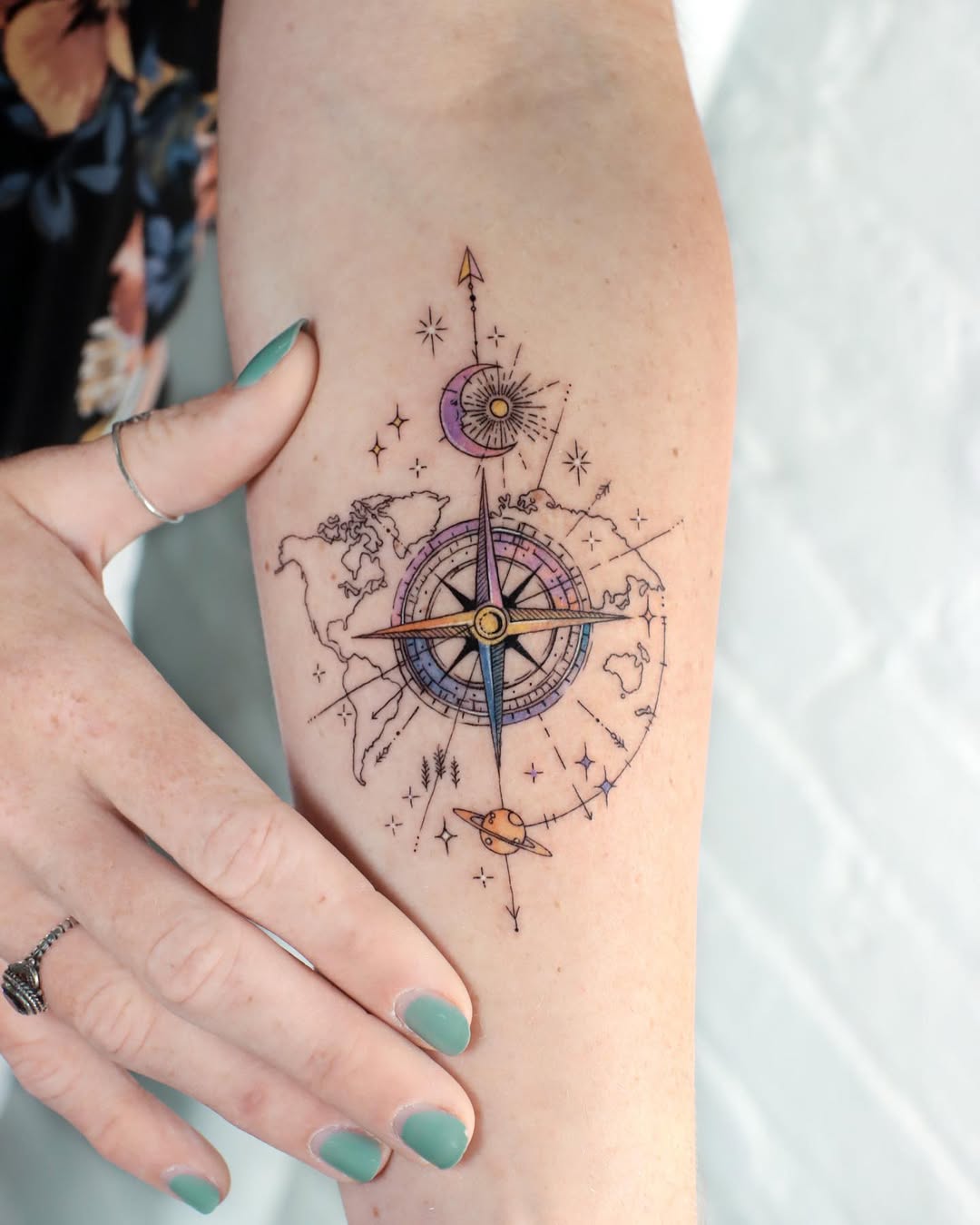 Intricate compass tattoo with celestial elements