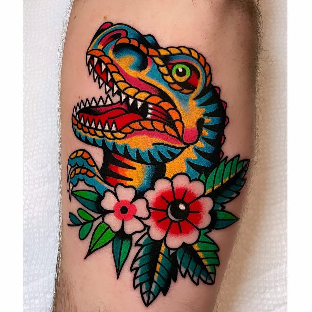 Vibrant dinosaur tattoo adorned with flowers