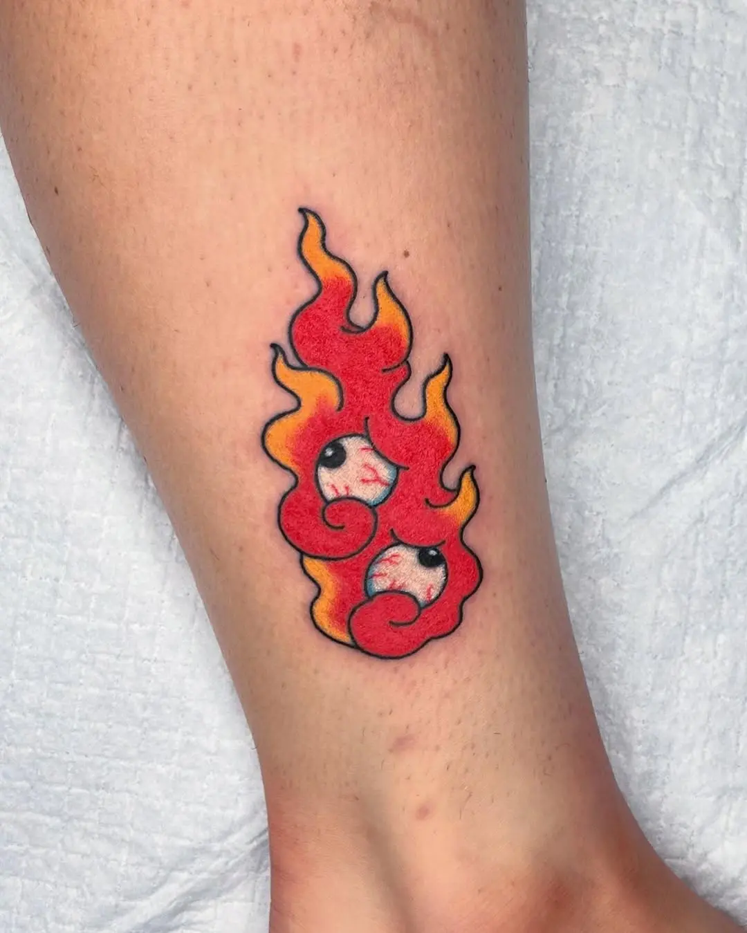 Whimsical Fire Tattoo with Playful Faces