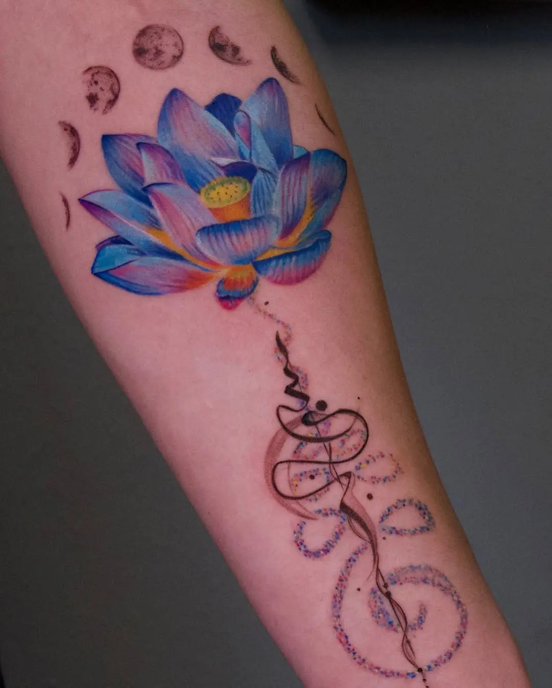 Vibrant lotus tattoo with celestial elements