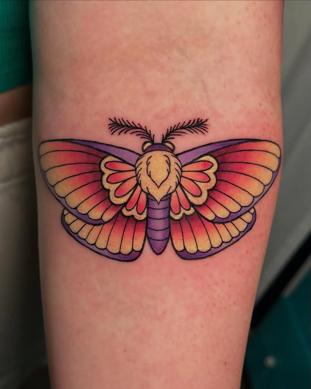 A vibrant moth tattoo in stunning detail