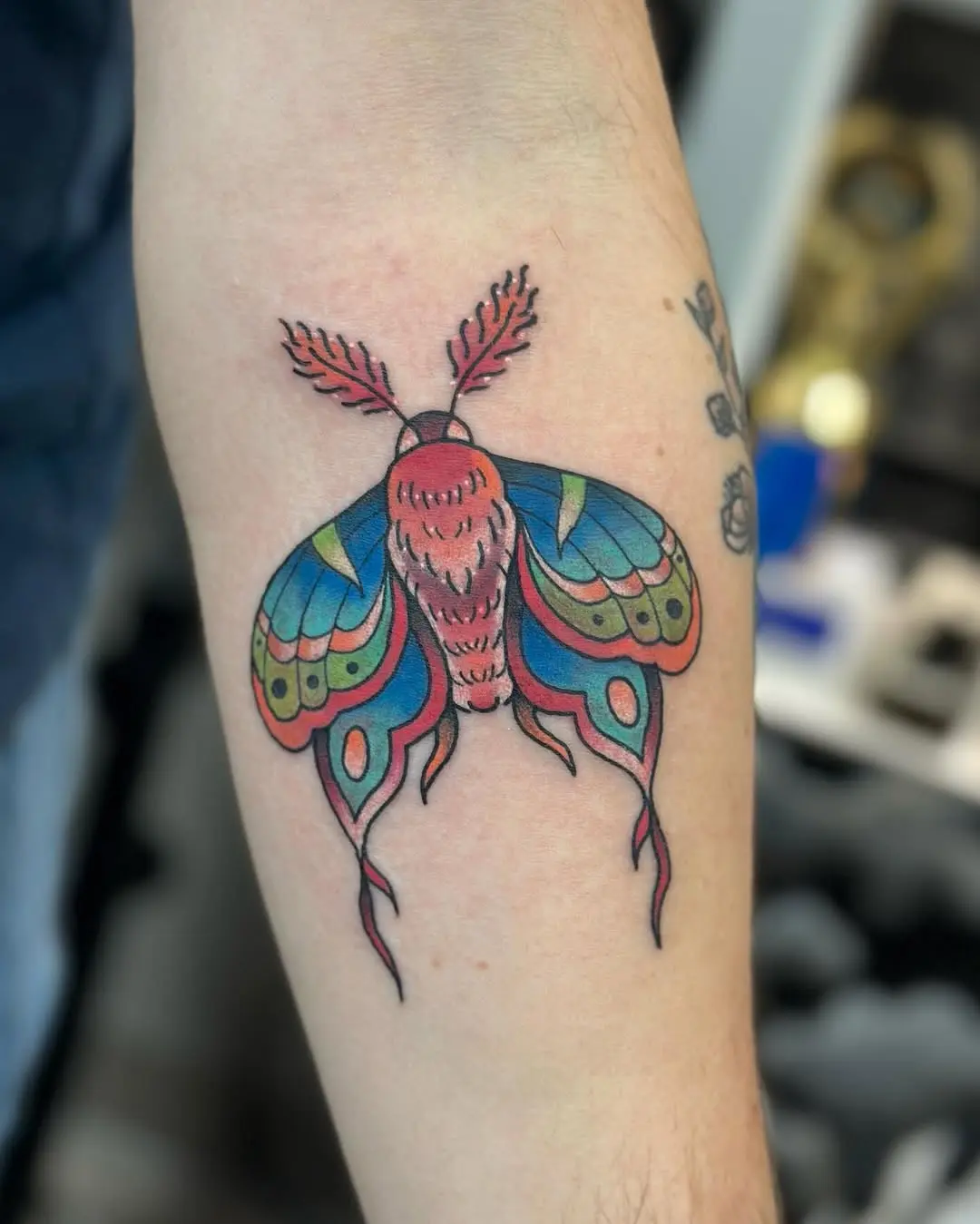 Stunning colorful moth tattoo with intricate details