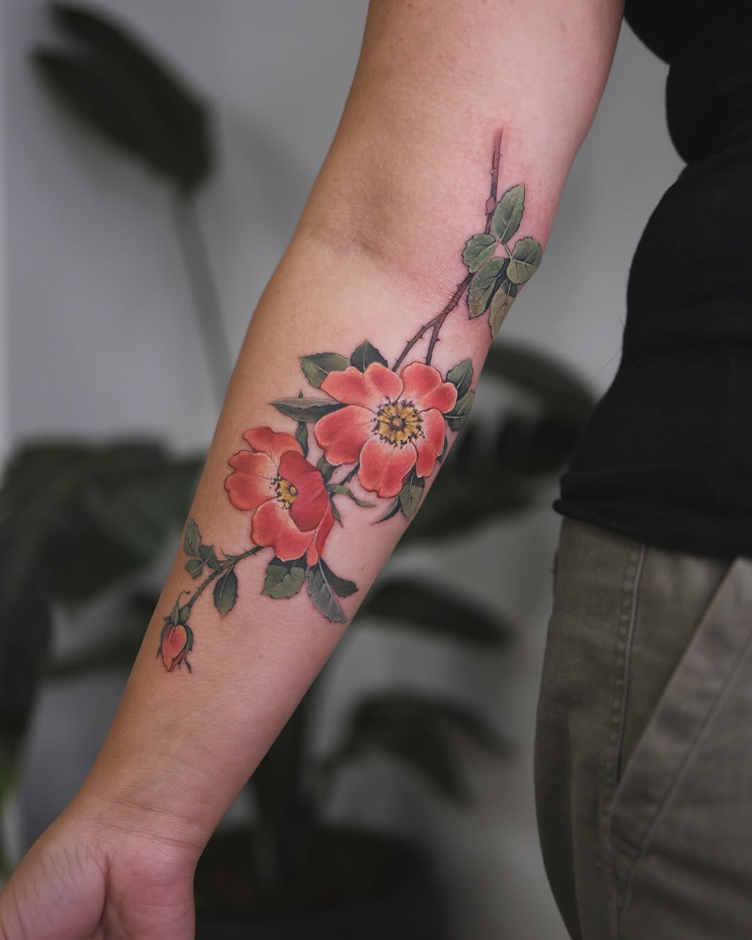 Stunning floral arm tattoo with vibrant roses