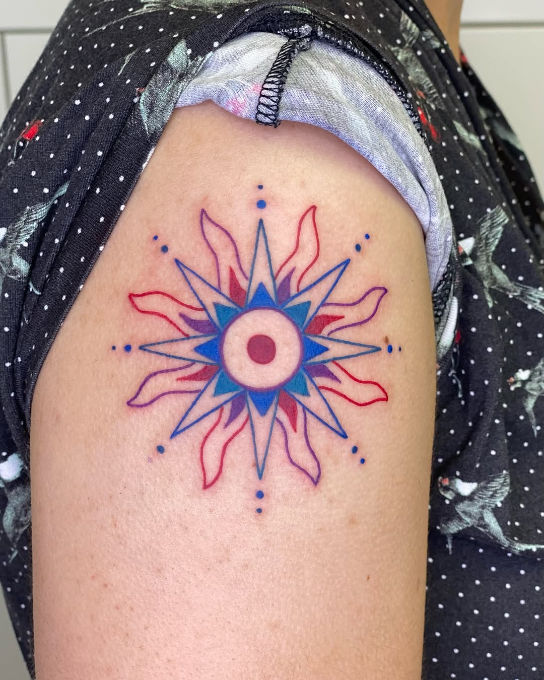 Vibrant sun tattoo with intricate design details