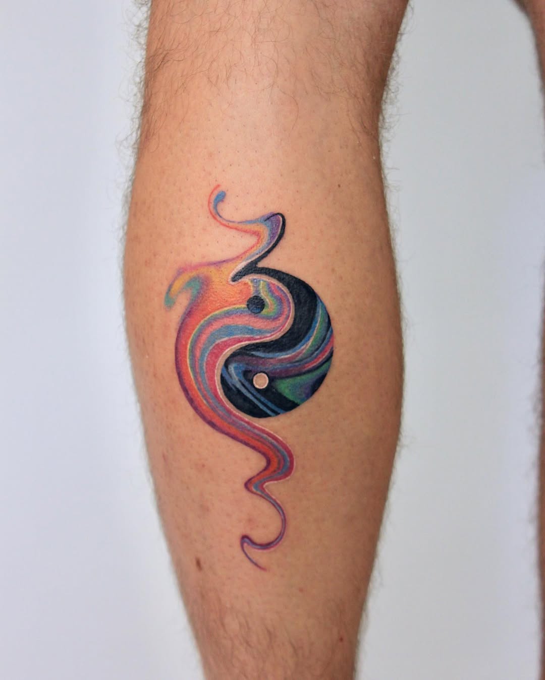 Artistic yin yang tattoo with colorful swirls