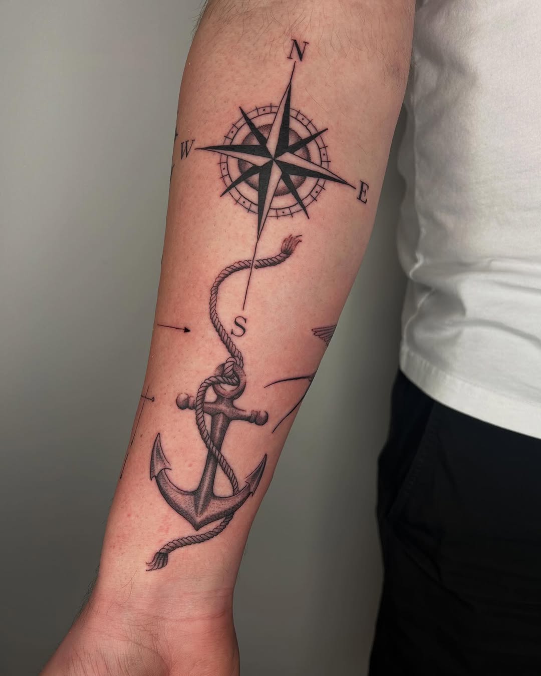 Intricate compass and anchor tattoo design