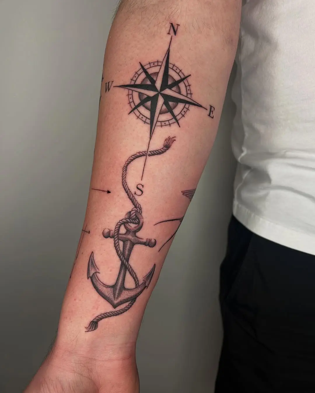 Intricate compass and anchor tattoo design