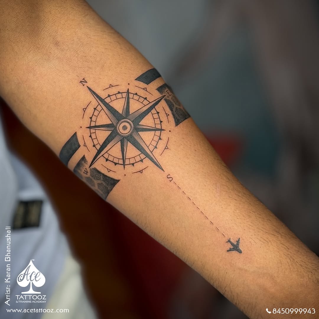 Stylish compass tattoo with airplane design