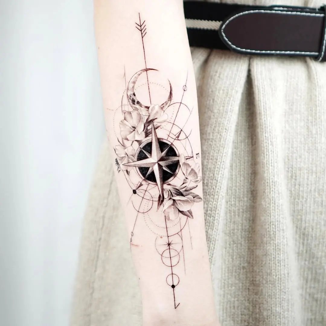 Intricate compass tattoo with floral elements