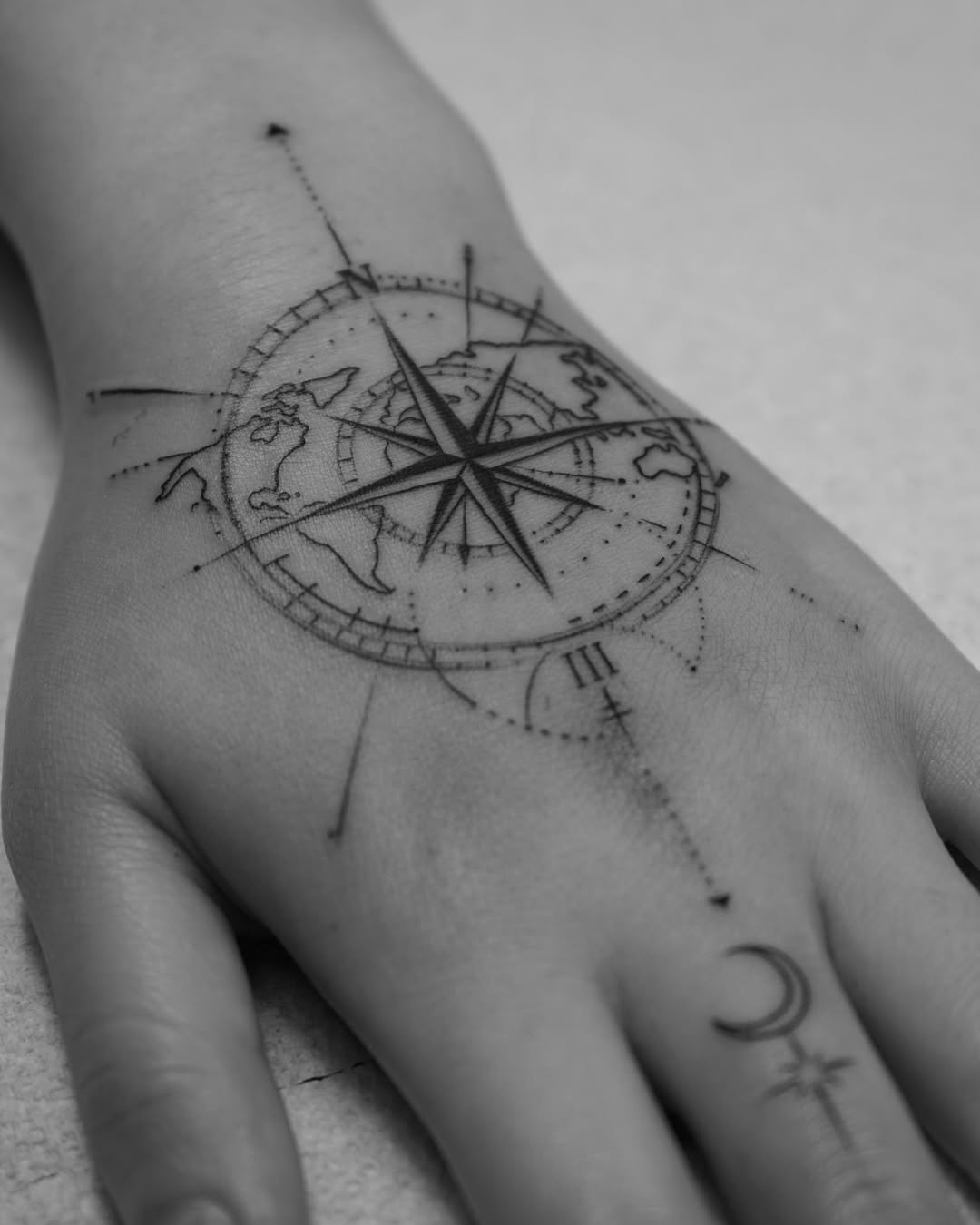 Intricate compass tattoo on hand design