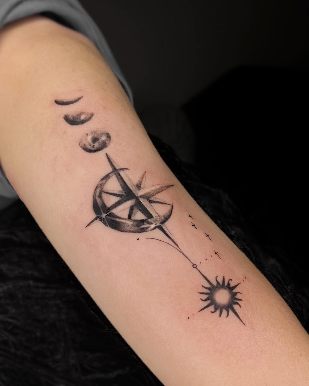 Artistic compass tattoo with moon phases