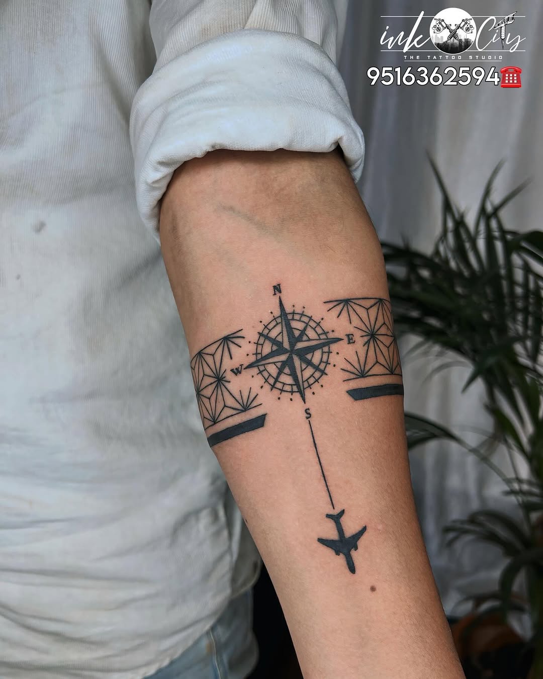 Elegant compass tattoo with airplane and bamboo