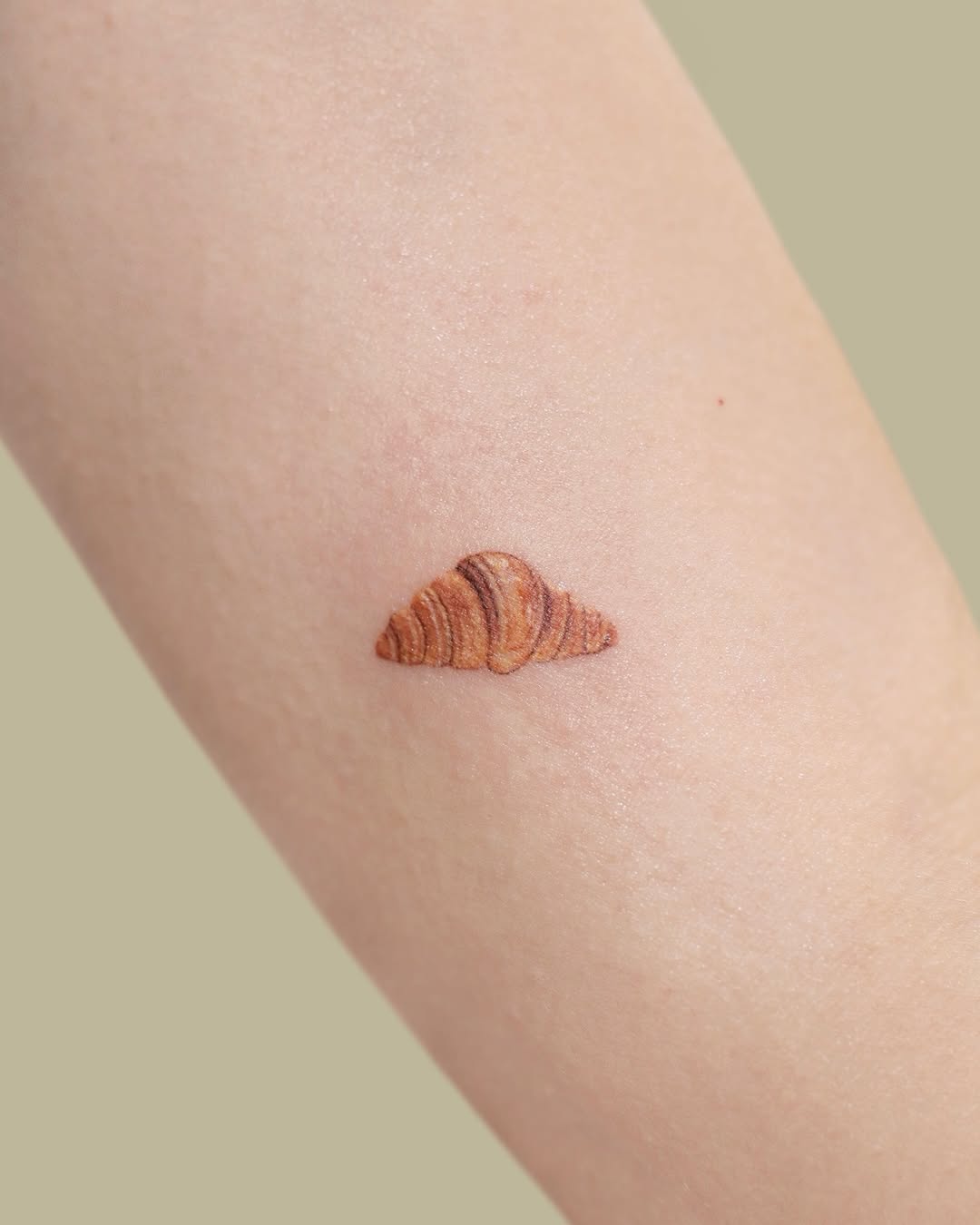 Delicious croissant tattoo with intricate detail