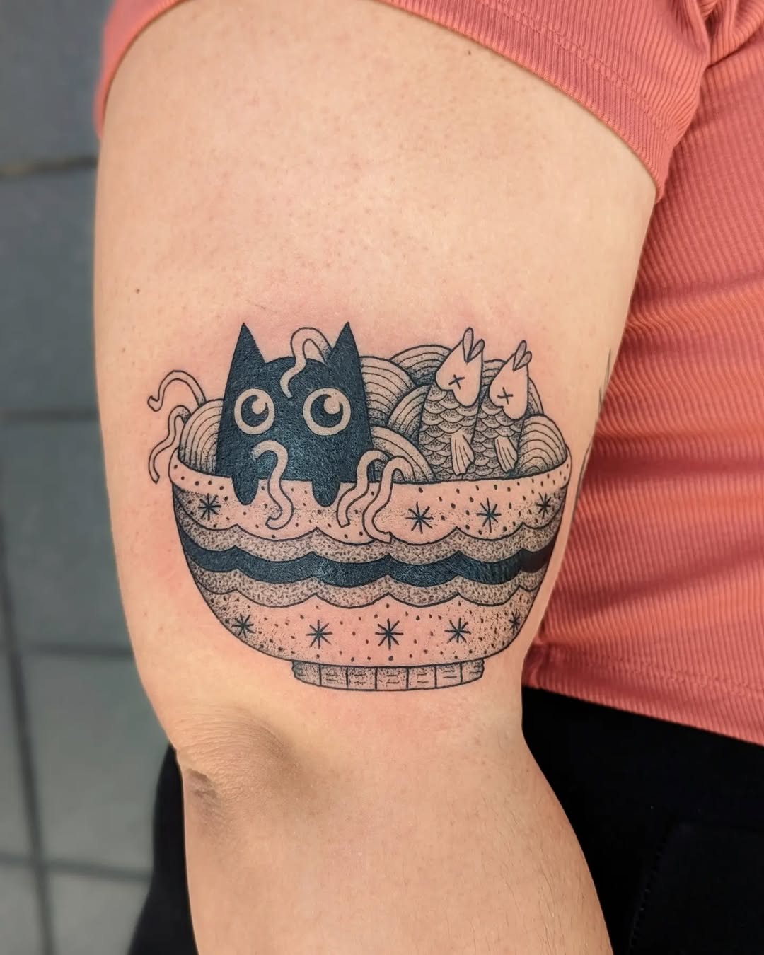 Whimsical food-themed tattoo featuring a cat