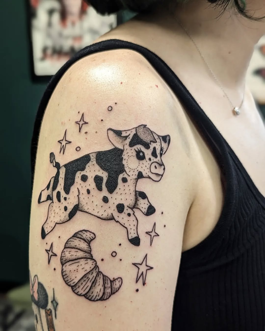 Whimsical cow and croissant culinary tattoo