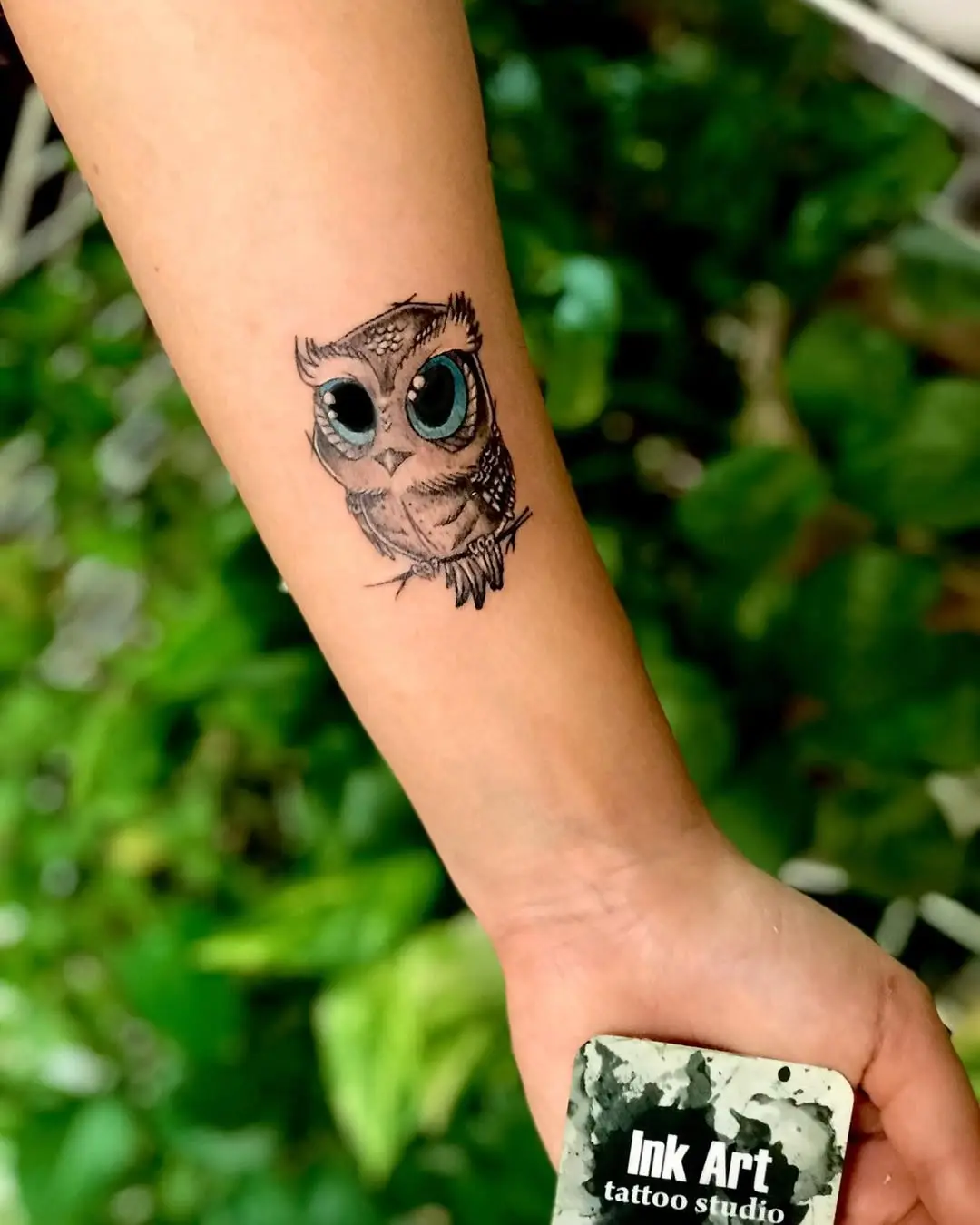 Whimsical owl tattoo with big expressive eyes