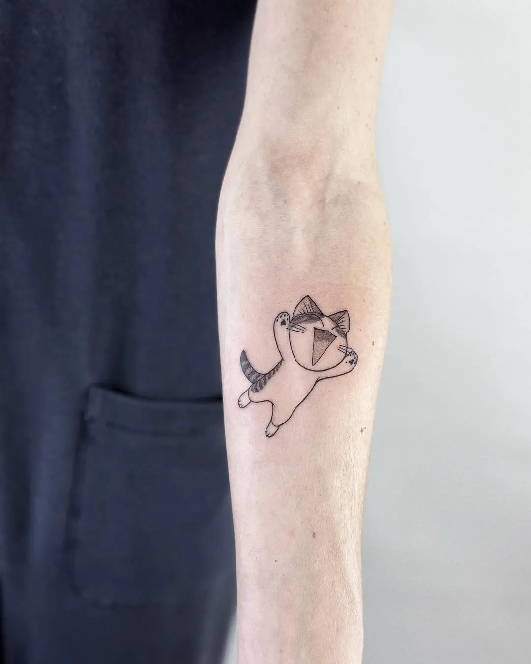Adorable small cat tattoo for a fun vibe