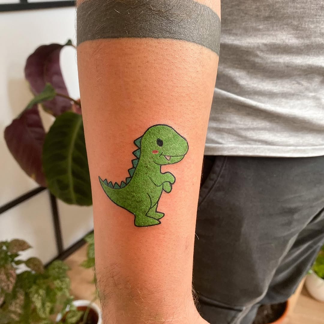 Playful Green Dinosaur Tattoo with Charm