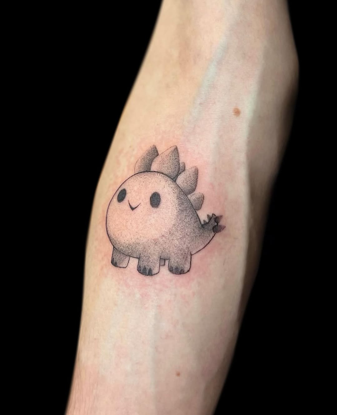 Adorable cartoon stegosaurus tattoo design