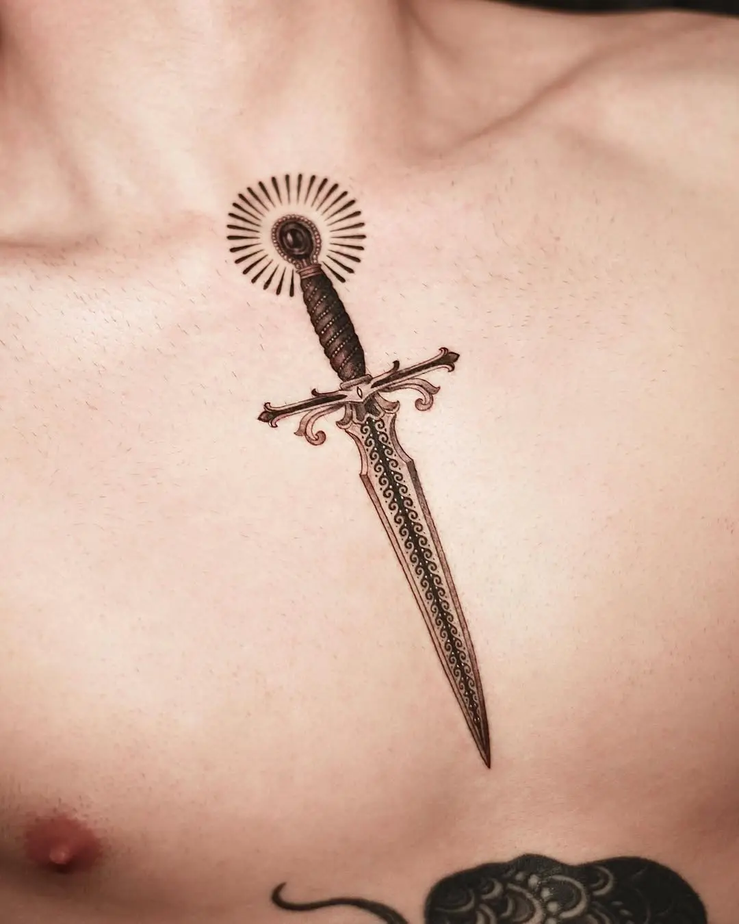 Intricate dagger tattoo with radiant outline