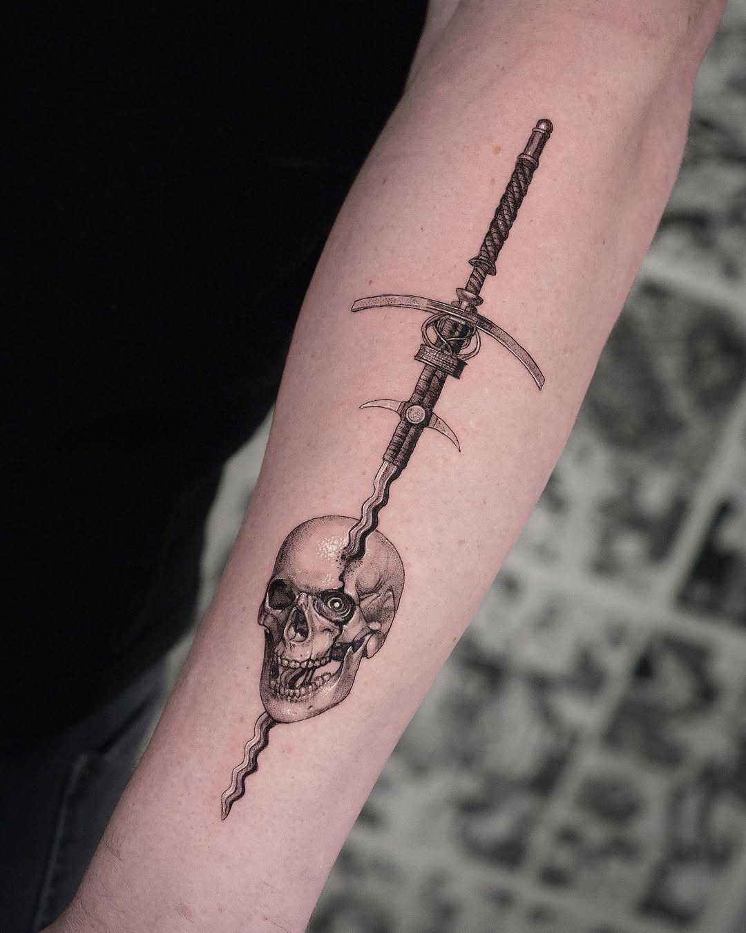 Striking dagger piercing through a skull tattoo