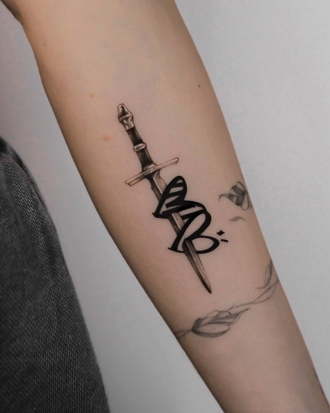 Intricate dagger and snake tattoo design