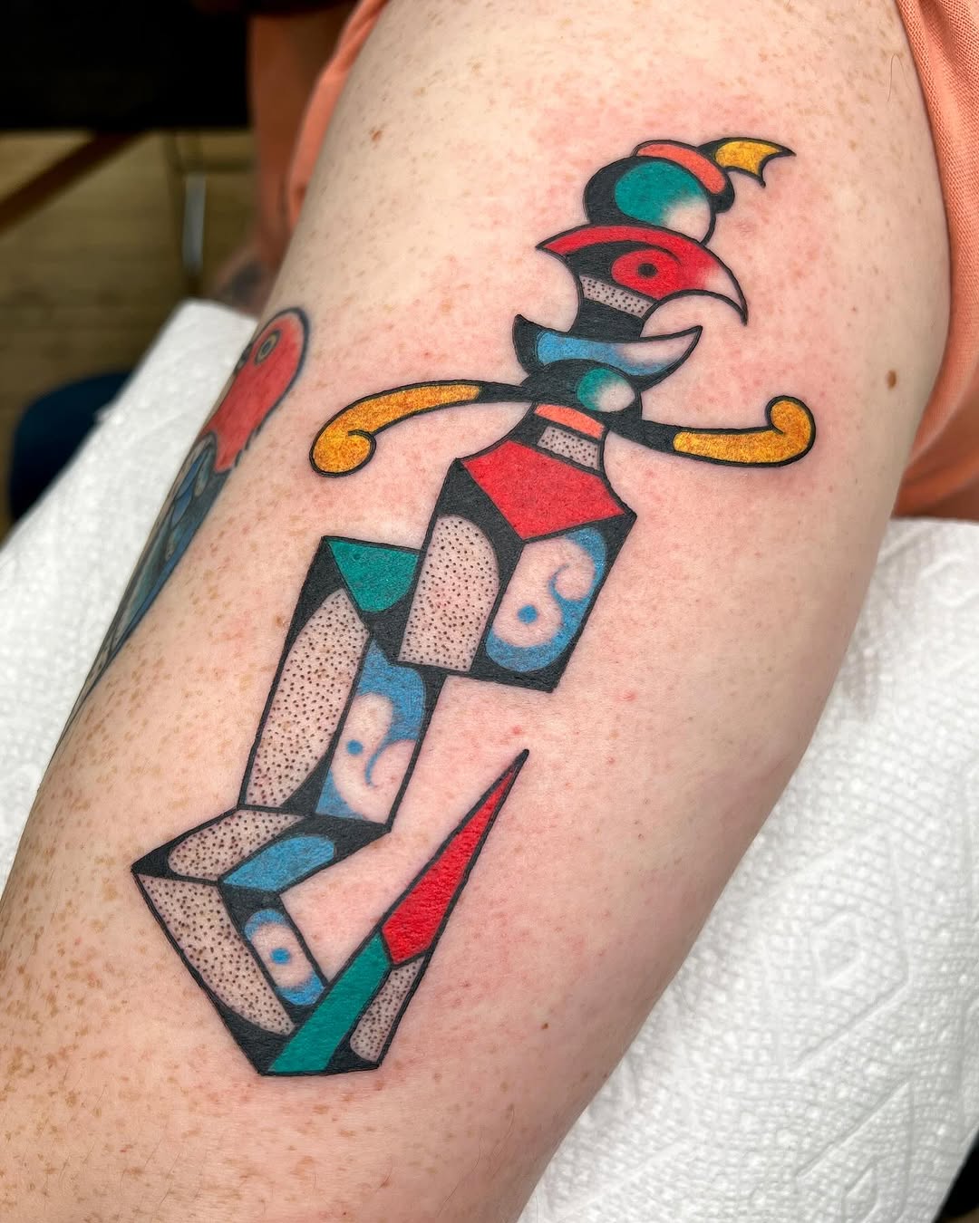 Vibrant geometric dagger tattoo on the arm