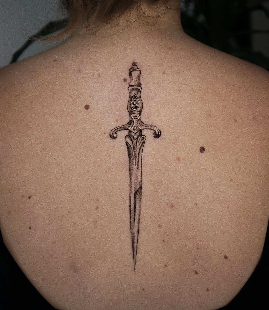 Elegant Dagger Tattoo on the Back