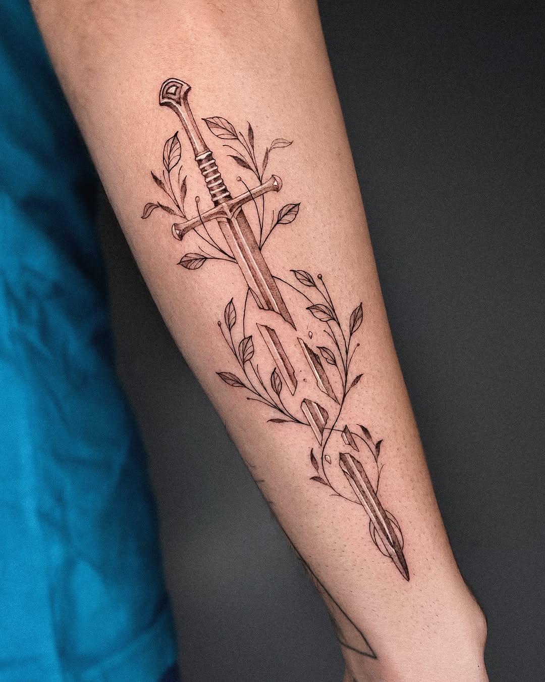 Stylish dagger tattoo with floral accents